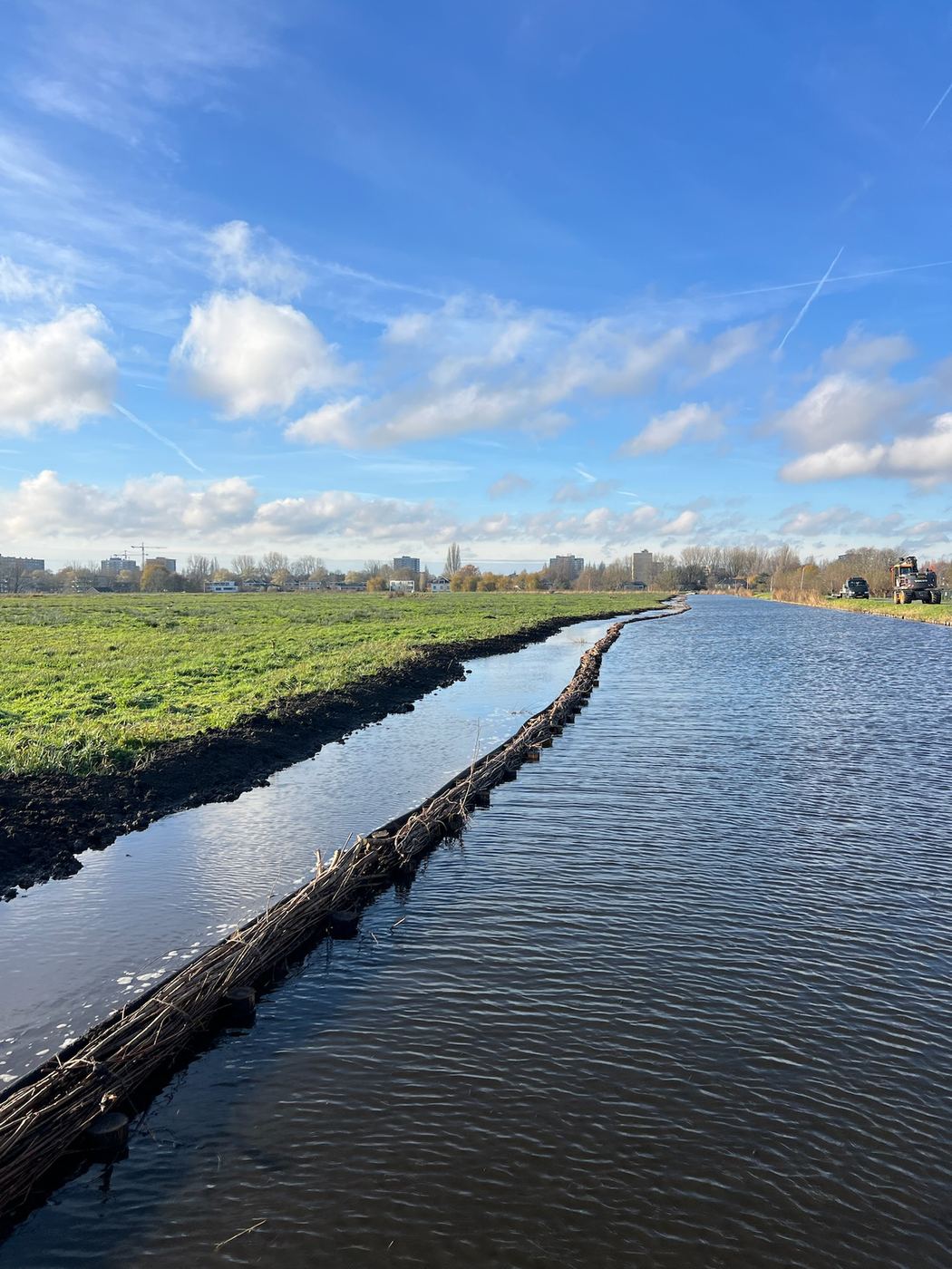 Nieuwe beschoeiing langs een lange sloot in het weiland